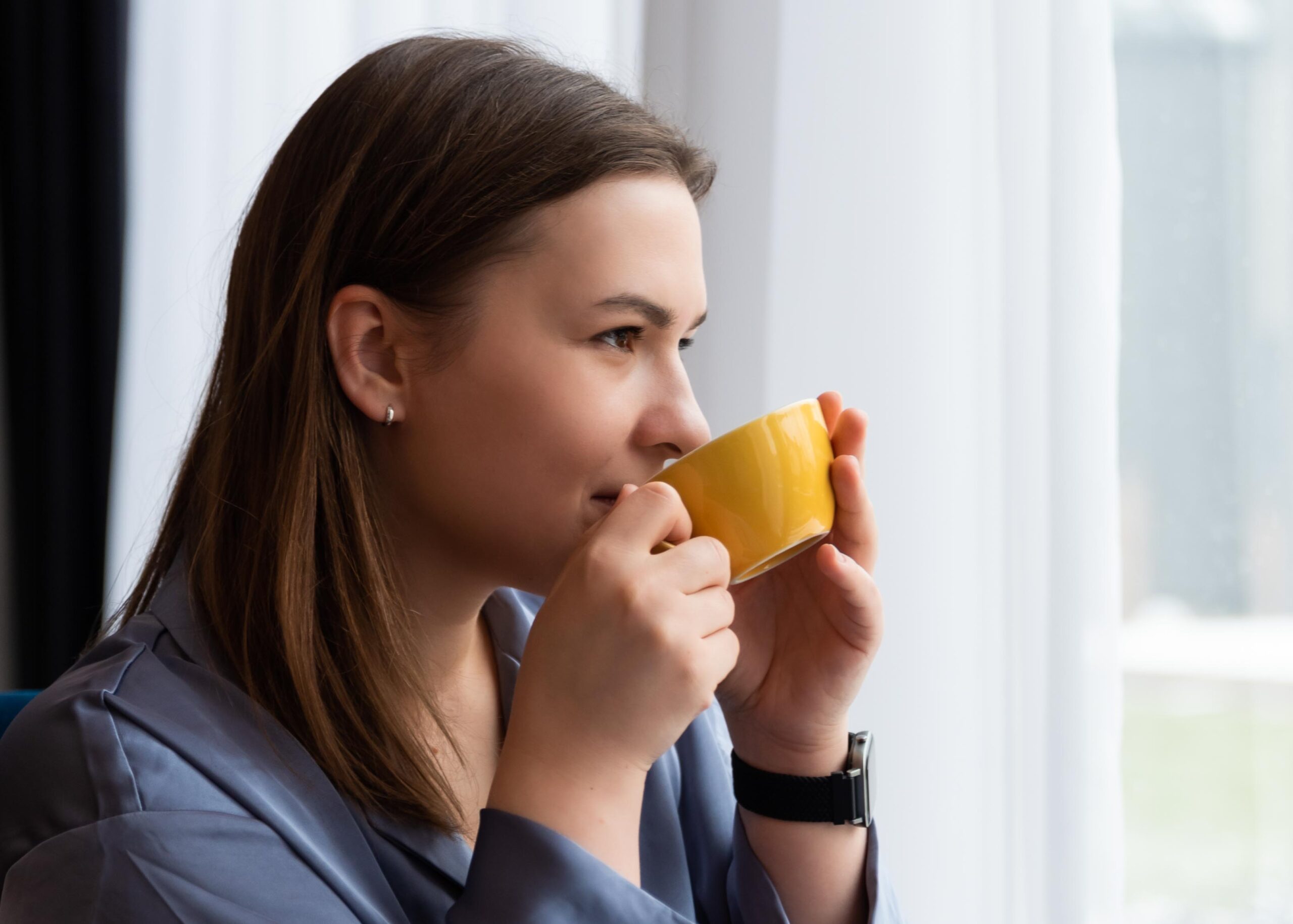 Girl is holding a cuo of coffee